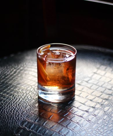 An old fashioned cocktail on a snakeskin surface
