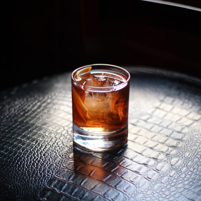 An old fashioned cocktail on a snakeskin surface