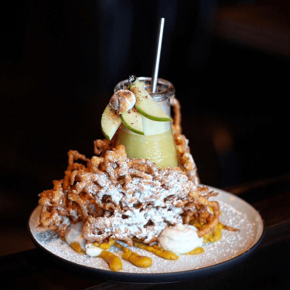 A cocktail surrounded by funnel cake at Westbound in LA.